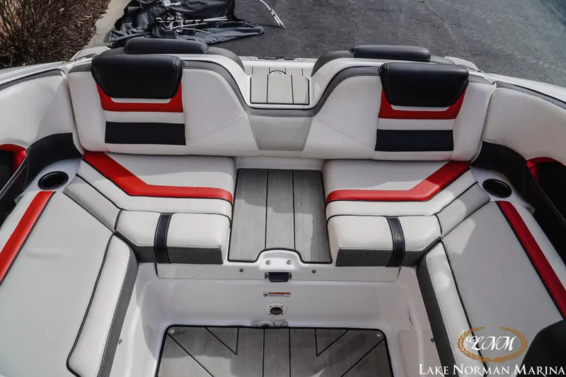 Slide: The Image of 2020 Yamaha Boats 212X interior with red, black, and white seating at Lake Norman Marina. - 16