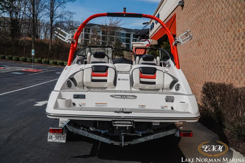 Slide: The Image of 2020 Yamaha Boats 212X parked at Lake Norman Marina, showcasing sleek design and vibrant red accents. - 4