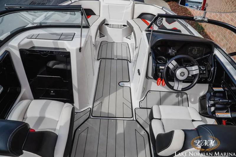 Slide: The Image of 2020 Yamaha Boats 212X interior with sleek seating and modern dashboard at Lake Norman Marina. - 7