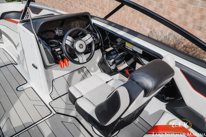 Slide: The Image of 2020 Yamaha Boats 212X cockpit with steering wheel and seating, Lake Norman Marina. - 9