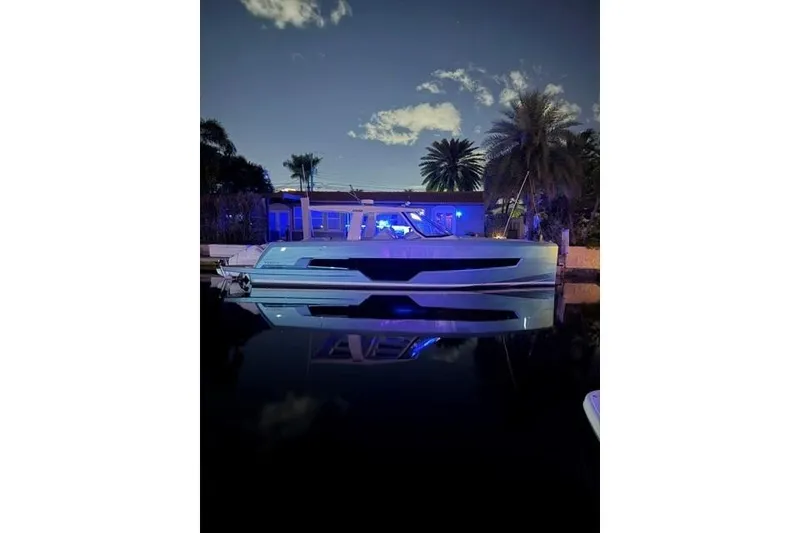 Slide: The Image of 2024 Fjord 41XP yacht illuminated at night, reflecting on calm water. - 16