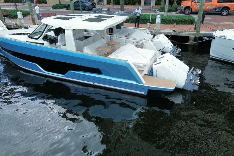 Slide: The Image of 2024 Fjord 41XP luxury yacht docked, featuring sleek design and powerful outboard engines. - 3