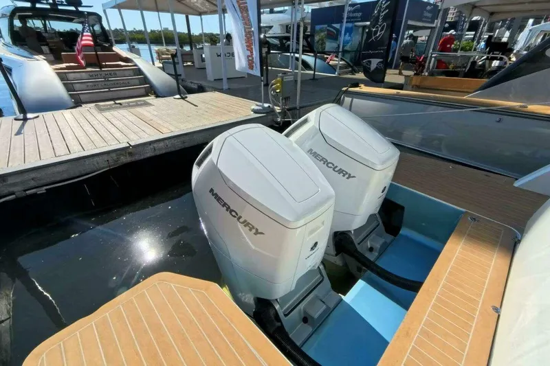 Slide: The Image of Twin Mercury outboard engines on a 2024 Fjord 41XP yacht at a marina. - 4