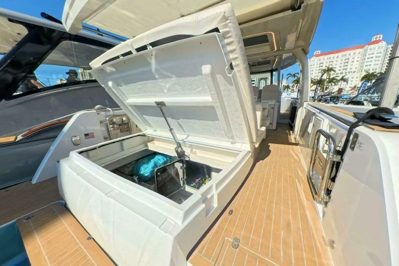 Slide: The Image of 2024 Fjord 41XP yacht with open storage compartment, docked under clear blue sky. - 7