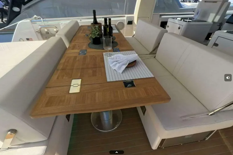 Slide: The Image of Luxurious seating area on 2024 Fjord 41XP yacht with elegant wooden table. - 9
