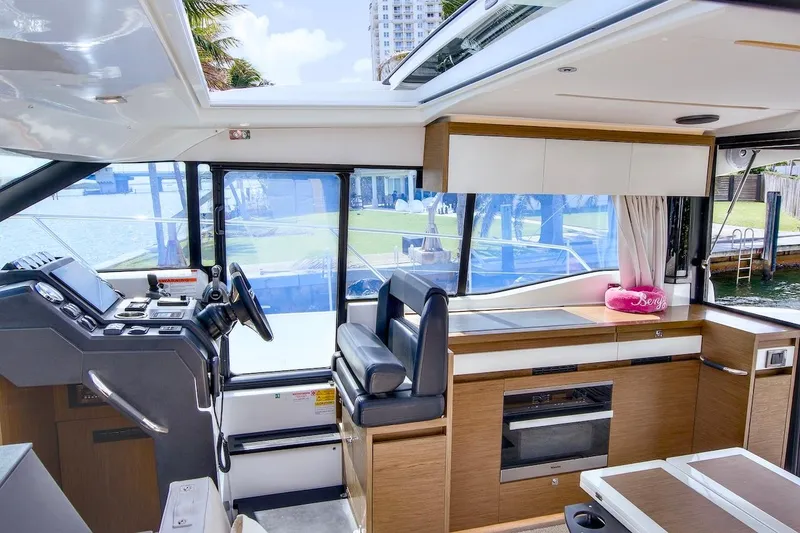 Slide: The Image of Interior of 2020 Jeanneau NC 37 yacht with modern helm and kitchen area. - 12