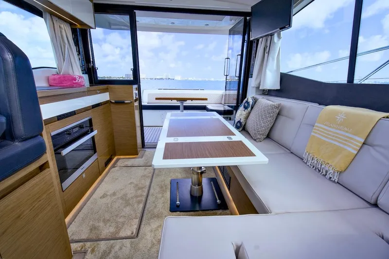 Slide: The Image of Interior of 2020 Jeanneau NC 37 yacht with modern seating and dining area. - 13