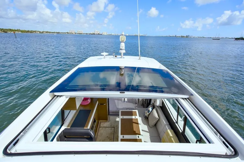 Slide: The Image of 2020 Jeanneau NC 37 yacht with open sunroof on calm water. - 15