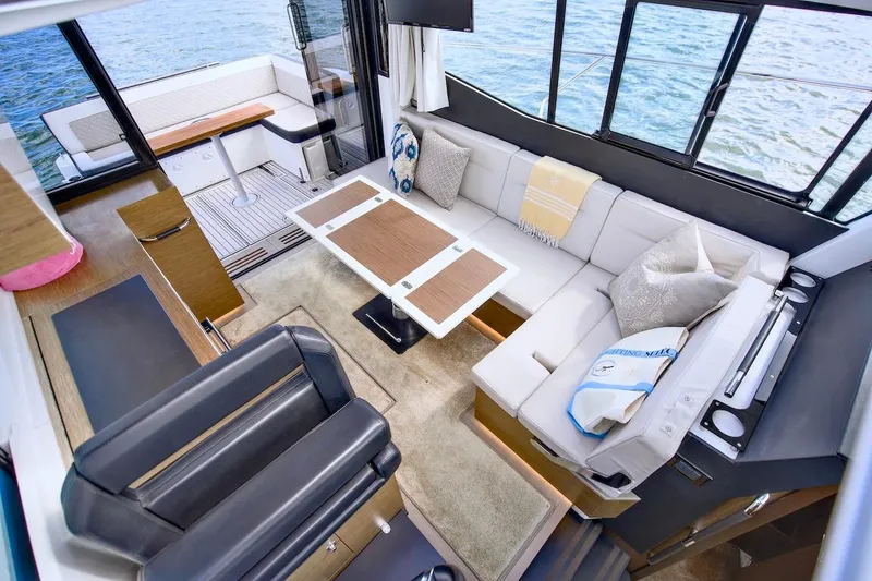 Slide: The Image of Interior of 2020 Jeanneau NC 37 yacht with modern seating and dining area. - 16