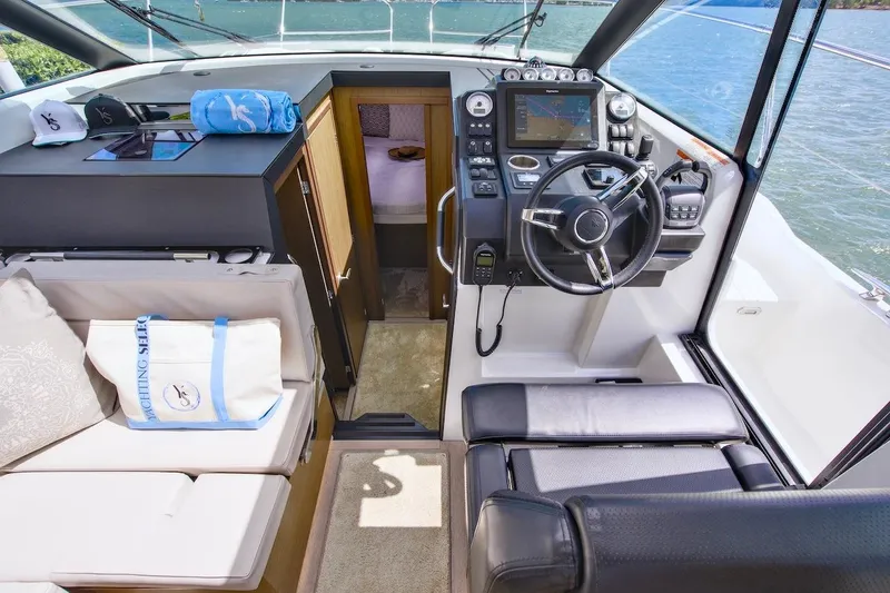 Slide: The Image of Interior view of 2020 Jeanneau NC 37 yacht cockpit with steering wheel and seating. - 19