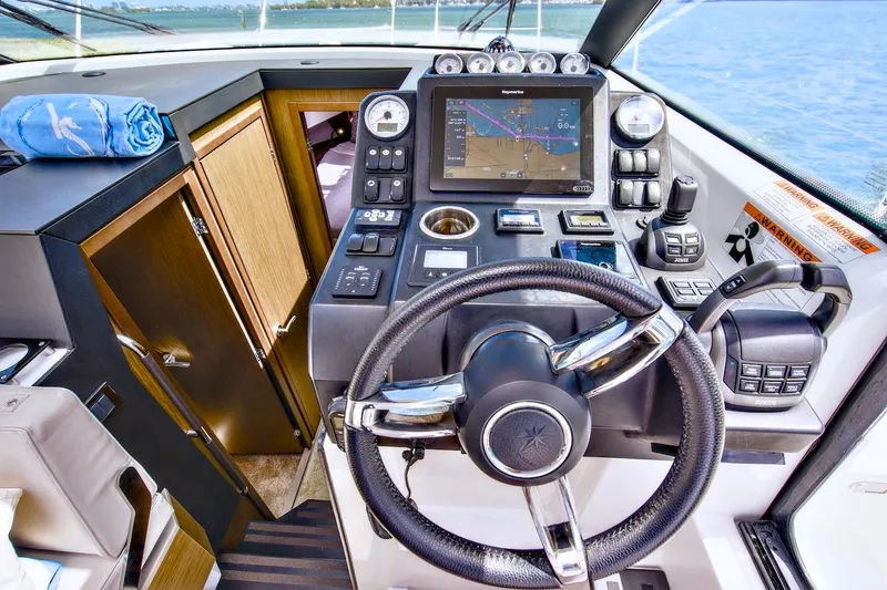 Slide: The Image of Cockpit of 2020 Jeanneau NC 37 boat with navigation controls and steering wheel. - 20