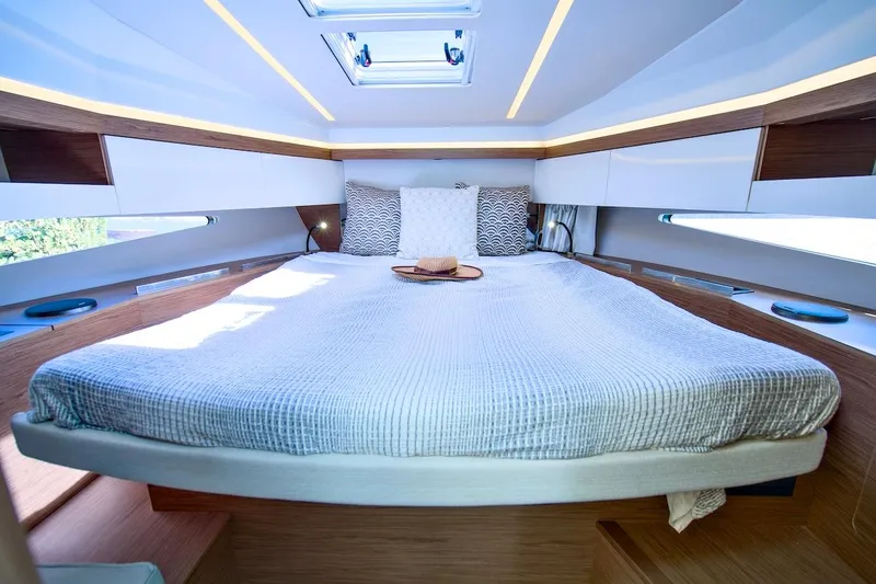 Slide: The Image of Luxurious cabin interior of 2020 Jeanneau NC 37 yacht with modern bedding. - 21