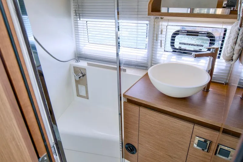 Slide: The Image of Modern bathroom interior of 2020 Jeanneau NC 37 yacht with sleek fixtures and wooden cabinetry. - 26