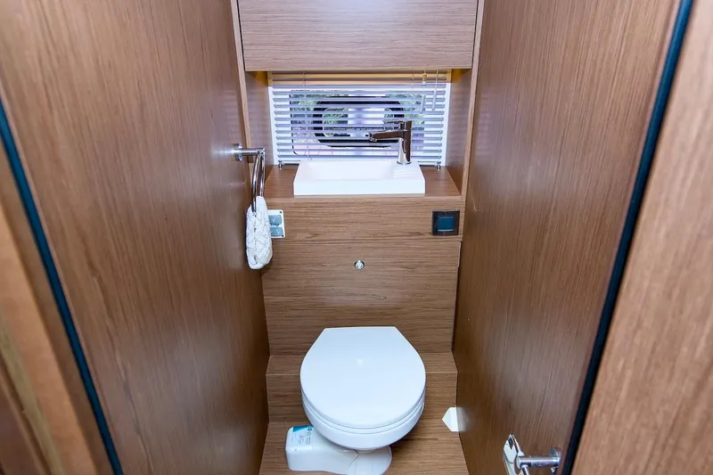 Slide: The Image of 2020 Jeanneau NC 37 boat bathroom with wooden interior and compact design. - 27