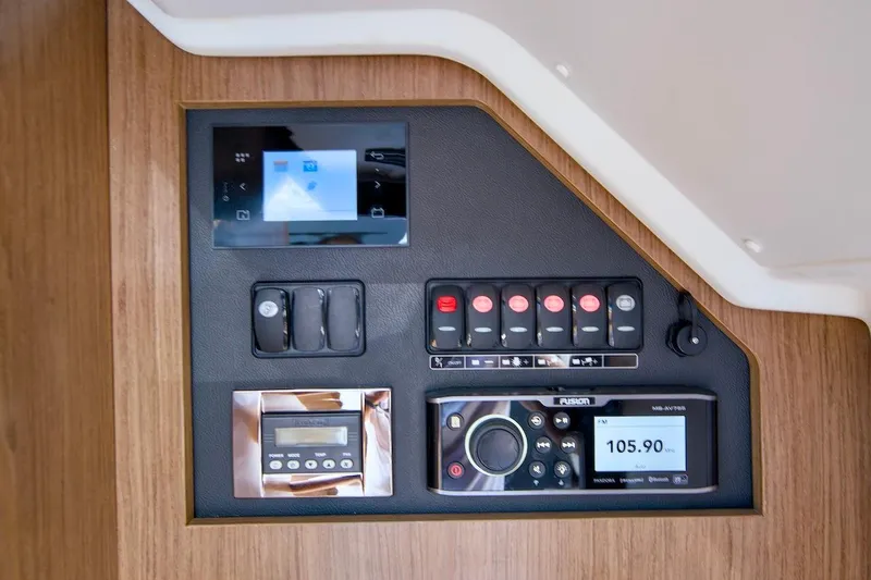 Slide: The Image of Control panel of 2020 Jeanneau NC 37 boat with electronic displays and switches. - 29