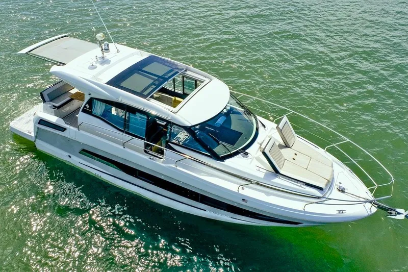 Slide: The Image of 2020 Jeanneau NC 37 yacht cruising on open water, showcasing sleek design and spacious deck. - 5