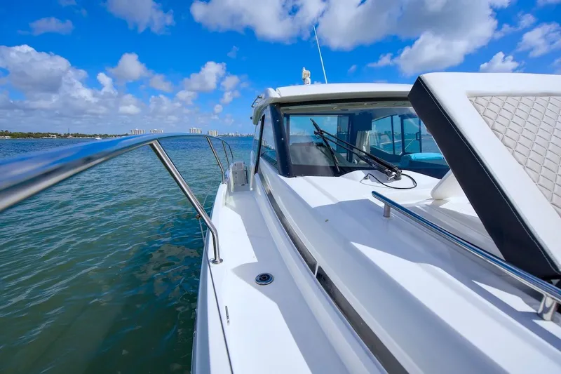 Slide: The Image of 2020 Jeanneau NC 37 yacht cruising on a sunny day with clear blue skies. - 8