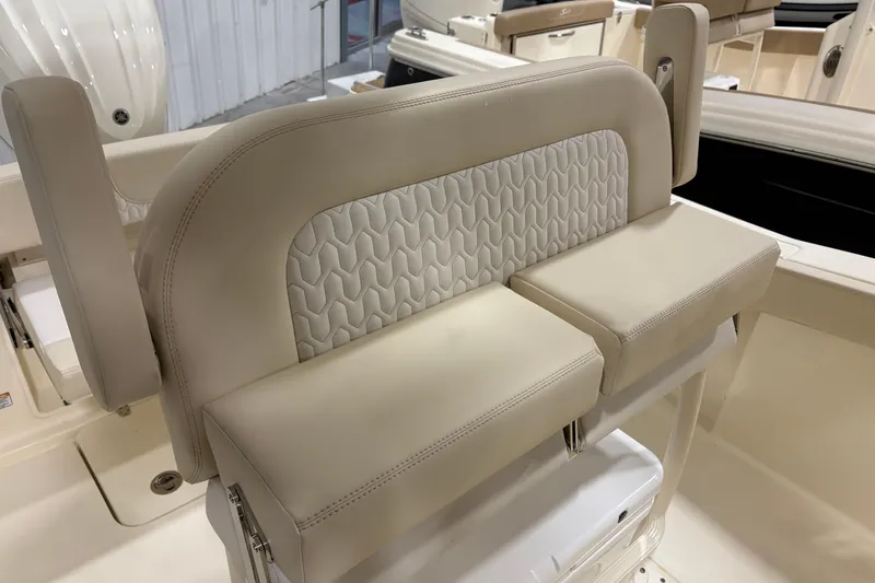 Slide: The Image of 2026 Scout 240 XSF boat seat with beige upholstery and textured backrest design. - 11