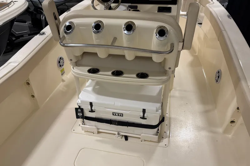 Slide: The Image of 2026 Scout 240 XSF boat interior with Yeti cooler and rod holders. - 13