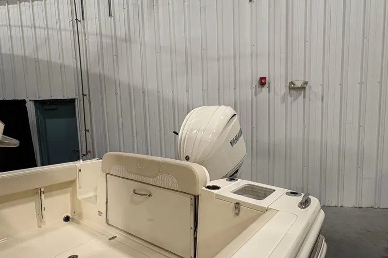 Slide: The Image of 2026 Scout 240 XSF boat with Yamaha outboard motor in a warehouse setting. - 16