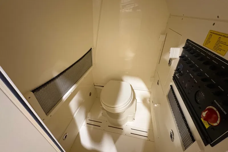 Slide: The Image of 2026 Scout 240 XSF boat interior with toilet and control panel. - 17