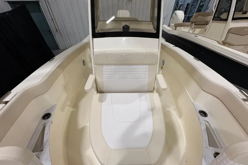 Slide: The Image of 2026 Scout 240 XSF boat interior with beige seating and cup holders. - 8