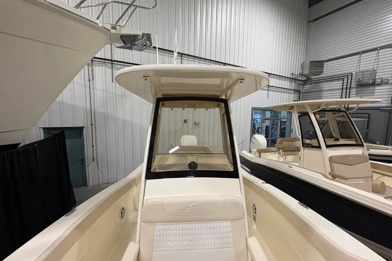 Slide: The Image of 2026 Scout 240 XSF boat in showroom, featuring sleek design and modern interior. - 9