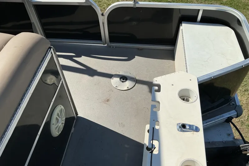 Slide: The Image of 2004 Voyager Pontoons 22 Super Fish & Cruise deck with seating and storage compartments. - 14