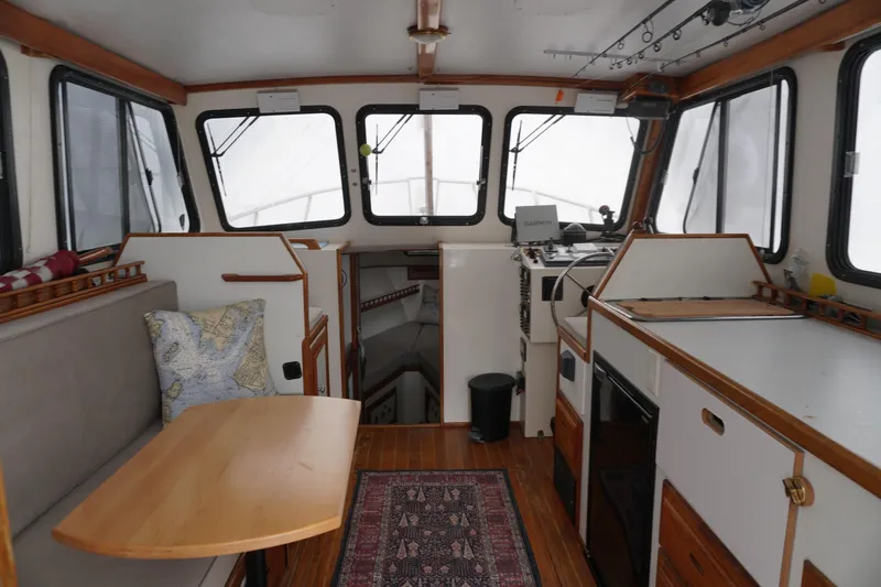 Slide: The Image of Interior of a 1999 Eastern 31 Casco Bay boat with cozy seating and navigation equipment. - 12