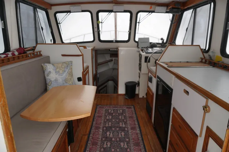 Slide: The Image of Interior of a 1999 Eastern 31 Casco Bay boat with wood accents and seating area. - 14