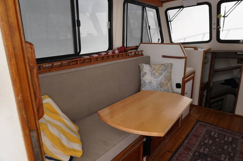 Slide: The Image of Interior of a 1999 Eastern 31 Casco Bay boat with cozy seating and wooden table. - 15