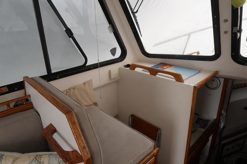 Slide: The Image of Interior of a 1999 Eastern 31 Casco Bay boat with seating and navigation area. - 18