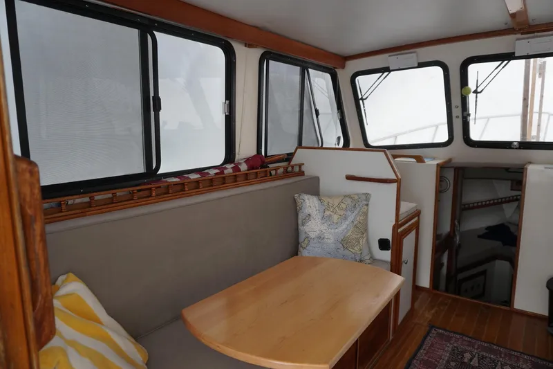 Slide: The Image of Interior of 1999 Eastern 31 Casco Bay boat with cozy seating and nautical decor. - 2