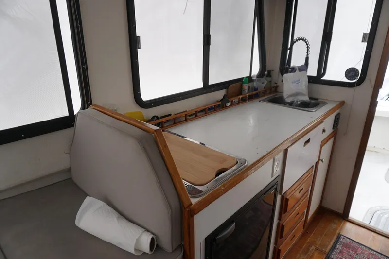 Slide: The Image of Interior of a 1999 Eastern 31 Casco Bay boat with kitchenette and seating area. - 20