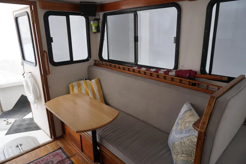 Slide: The Image of Interior of 1999 Eastern 31 Casco Bay boat with cozy seating and wooden table. - 21