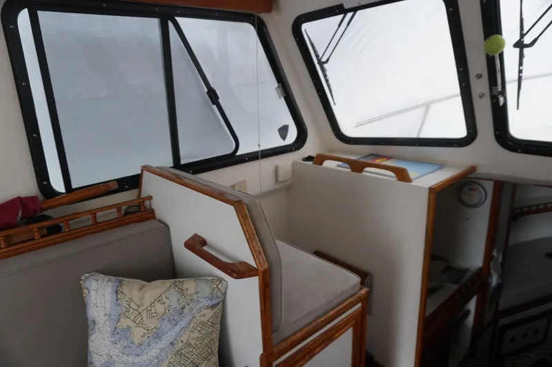 Slide: The Image of Interior of a 1999 Eastern 31 Casco Bay boat with map-themed pillow. - 3