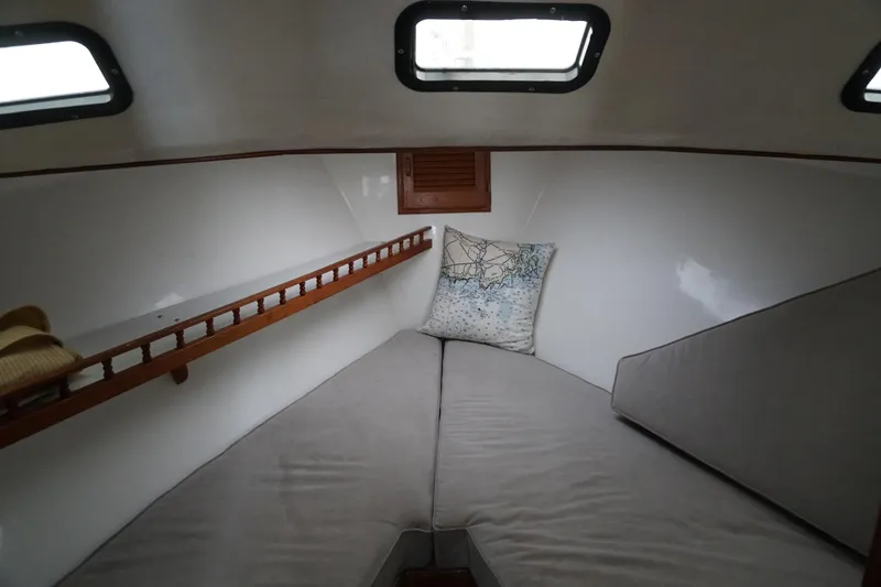 Slide: The Image of Cozy cabin interior of 1999 Eastern 31 Casco Bay boat with cushions and portholes. - 7