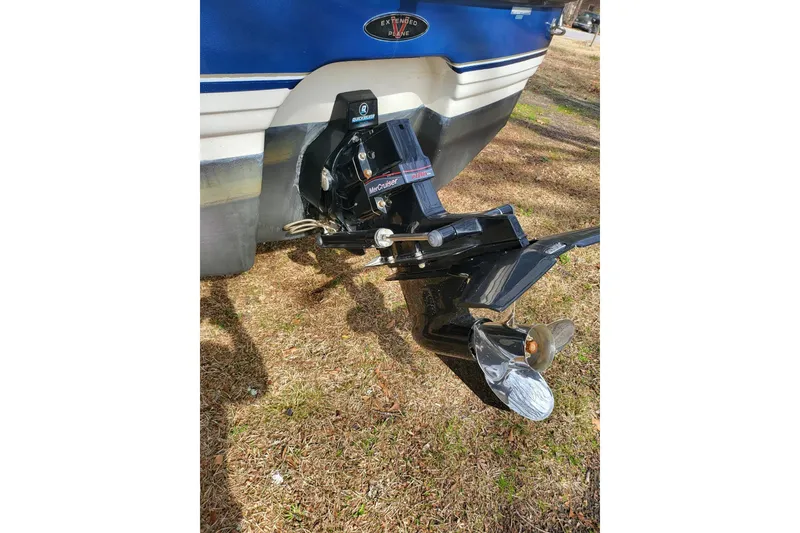 Slide: The Image of 1999 Chaparral Signature 240 boat with MerCruiser outdrive on grassy ground. - 9