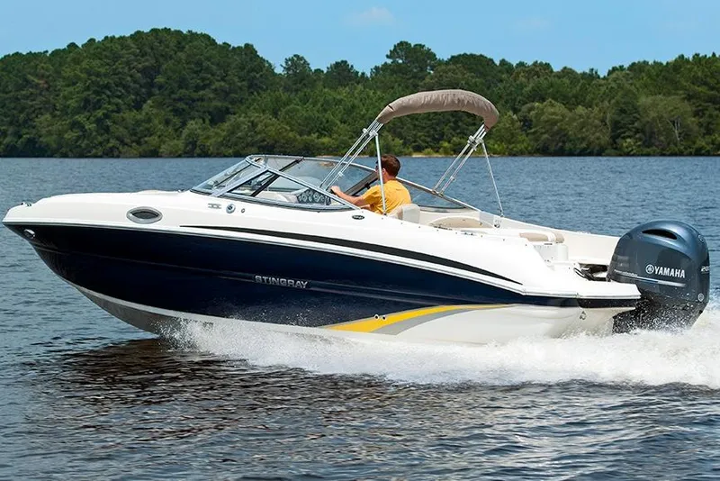 Slide: The Image of Manufacturer Provided Image: 2018 Stingray 234 LR boat cruising on a lake with a Yamaha outboard motor. - 10