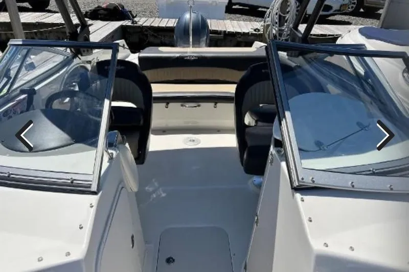 Slide: The Image of 2018 Stingray 234 LR boat interior with seating and windshield. - 3