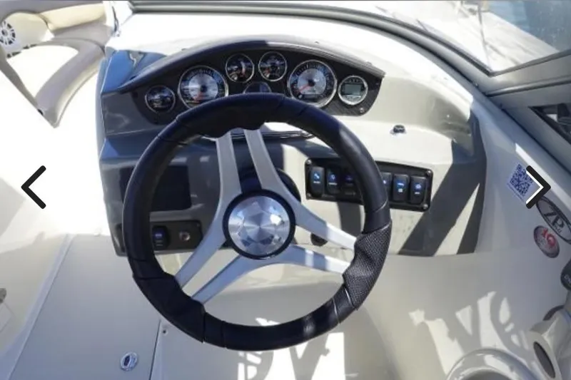 Slide: The Image of Steering wheel and dashboard of 2018 Stingray 234 LR boat, featuring gauges and controls. - 4