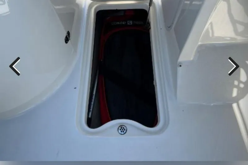 Slide: The Image of Storage compartment on 2018 Stingray 234 LR boat, featuring a neatly organized interior. - 6