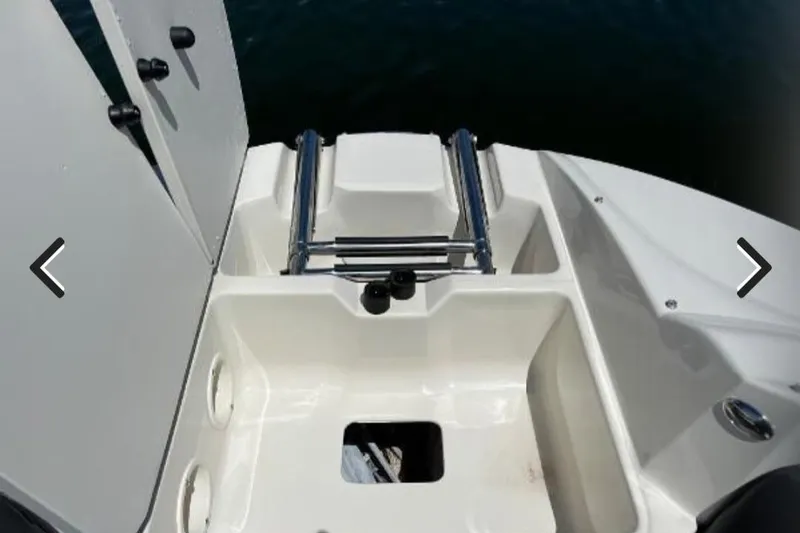 Slide: The Image of 2018 Stingray 234 LR boat swim platform with ladder and storage compartments. - 7