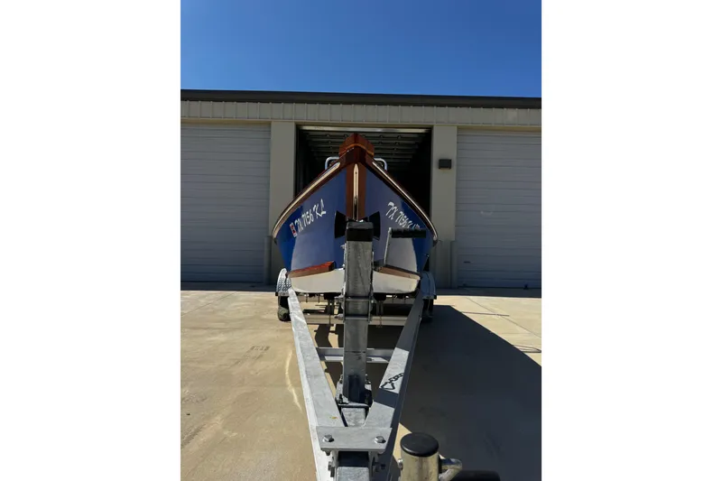 Slide: The Image of 2022 Farley Port A Skiff boat on trailer outside storage facility. - 10