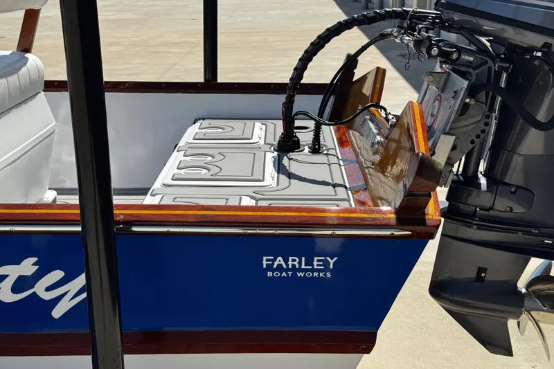 Slide: The Image of 2022 Farley Port A Skiff boat with motor, featuring sleek design and Farley Boat Works branding. - 12