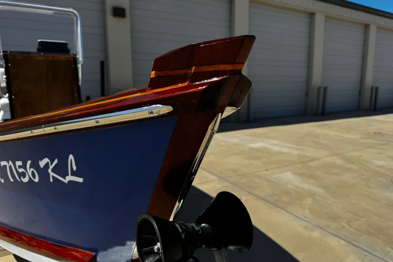 Slide: The Image of 2022 Farley Port A Skiff boat bow detail with registration number, parked near storage units. - 13