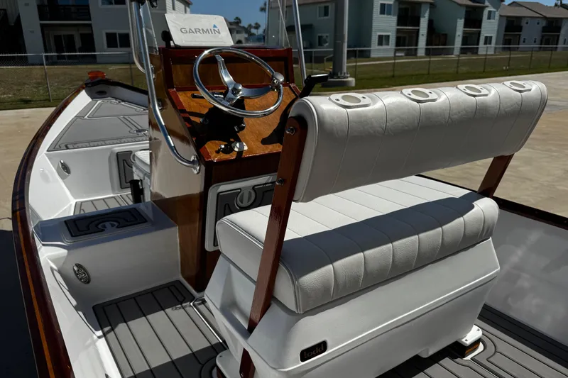 Slide: The Image of 2022 Farley Port A Skiff boat interior with Garmin navigation and white seating. - 15