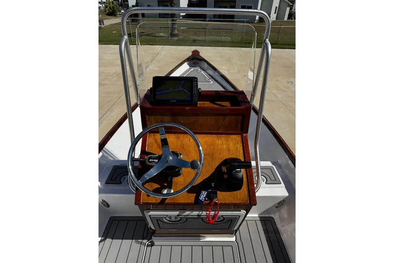 Slide: The Image of 2022 Farley Port A Skiff boat dashboard with steering wheel and navigation system. - 17