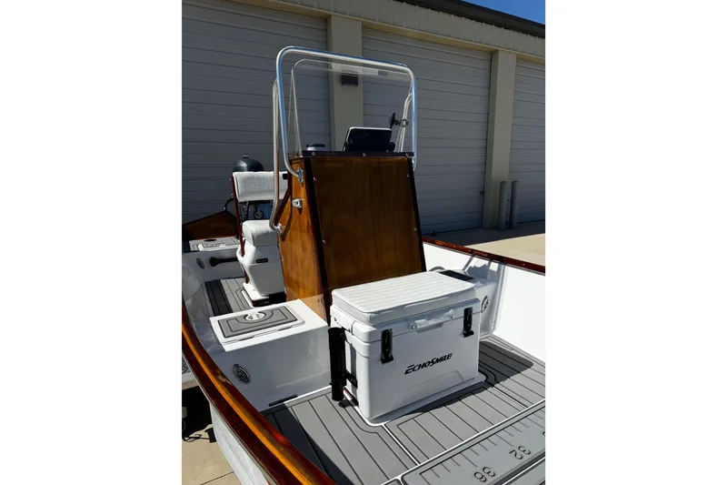 Slide: The Image of 2022 Farley Port A Skiff boat with center console and cooler on deck. - 18