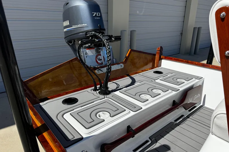 Slide: The Image of 2022 Farley Port A Skiff boat with Yamaha 70 outboard motor in a garage setting. - 19